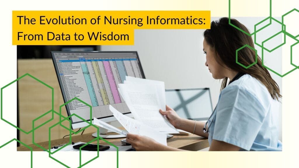 A female nurse reviews documents at her desk in front of a computer monitor.